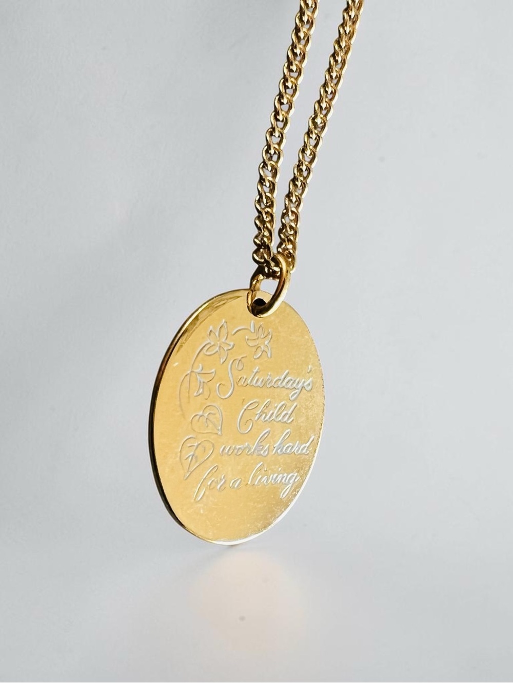 Avon Gold Toned Engraved Oval “Saturday’s Child” Pendant Necklace